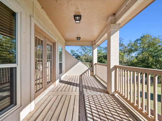a view of a patio with a table and chairs and potted plants