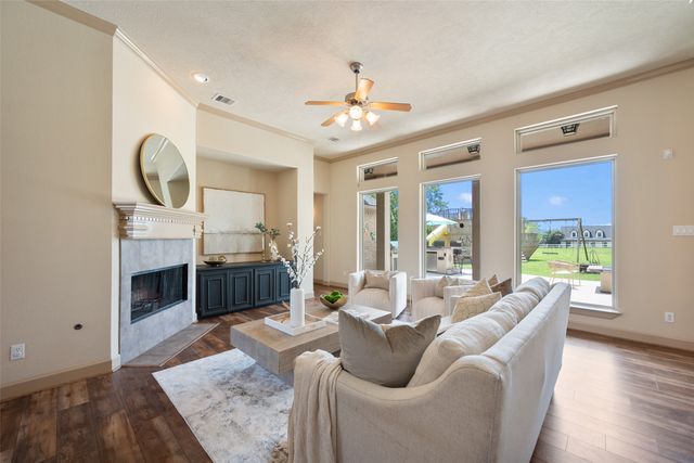 a living room with furniture a fireplace and a chandelier