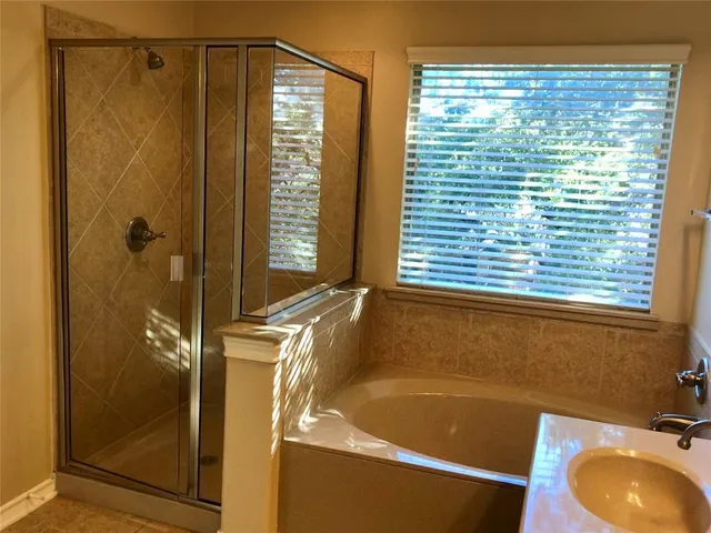 a bathroom with a tub and a sink