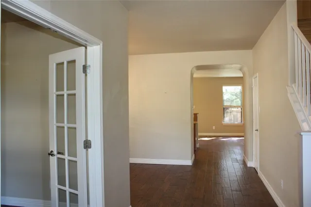a view of a hallway with wooden floor