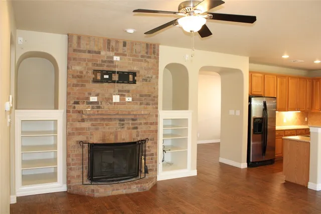a view of a kitchen with a refrigerator and a fireplace