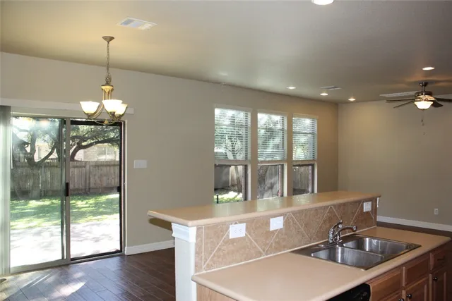 a room with lots of windows and a chandelier