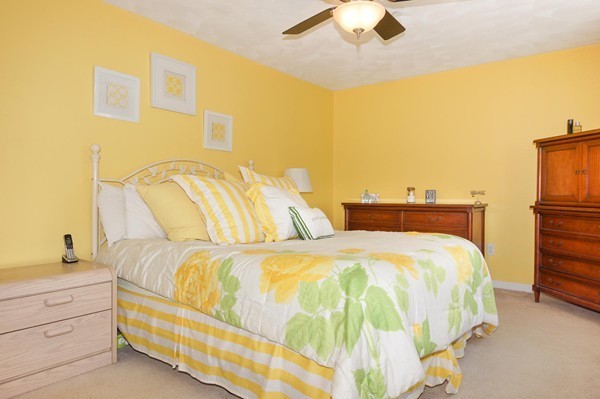 81 Salem Road, Unit 43 Billerica, MA 01821 - Photo 9 of 17 a bedroom with a bed and a chandelier