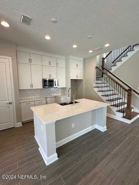 385 Rum Runner Way, Unit 49 St. Johns, FL 32259 - Photo 5 of 34 a large kitchen with kitchen island a sink a center island stainless steel appliances and a refrigerator