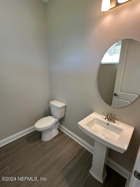 385 Rum Runner Way, Unit 49 St. Johns, FL 32259 - Photo 7 of 34 a bathroom with a toilet a sink and mirror