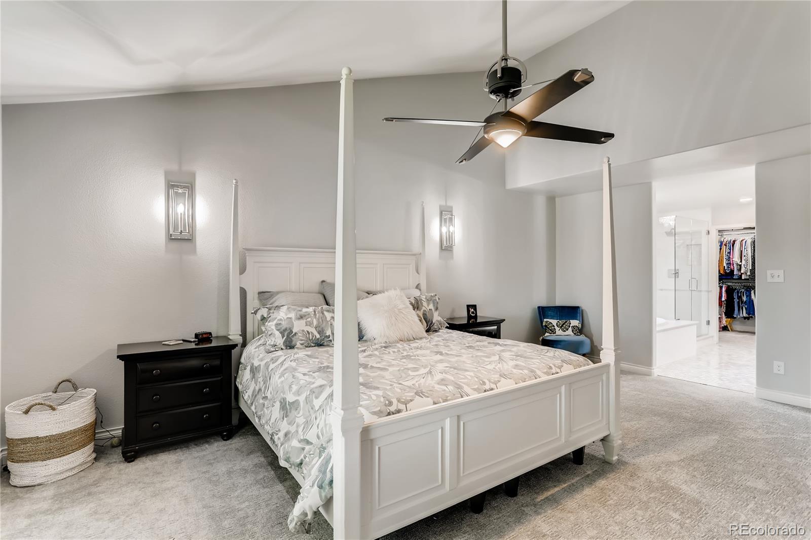 2883 East Ravenhill Circle Highlands Ranch, CO 80126 - Photo 11 of 25 a bedroom with a bed and a chandelier