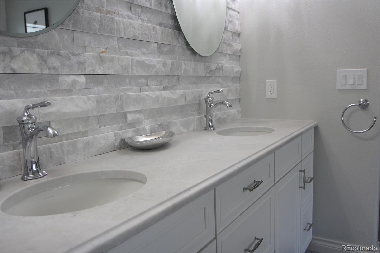 2883 East Ravenhill Circle Highlands Ranch, CO 80126 - Photo 13 of 25 a bathroom with a sink and a mirror