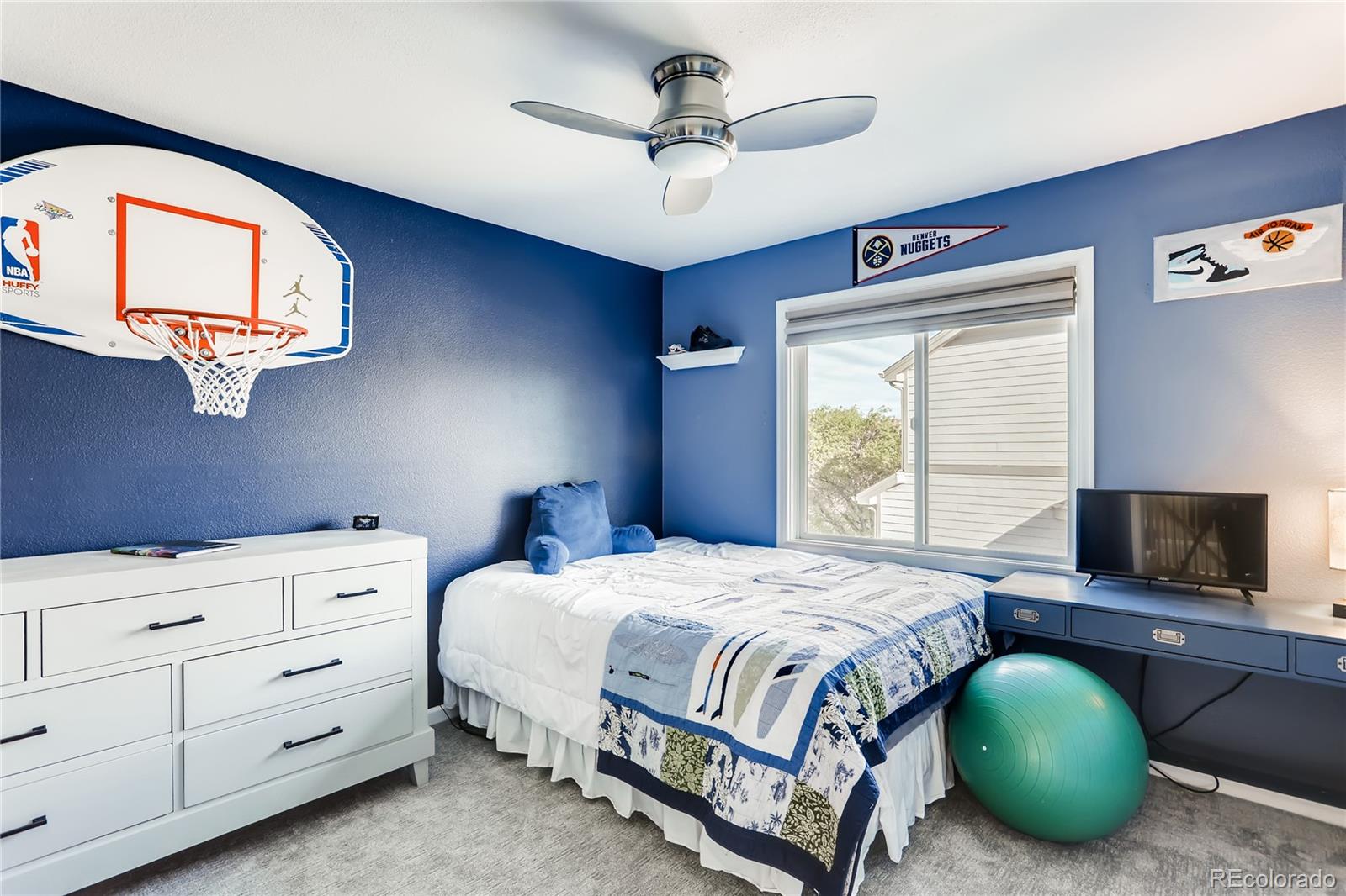 2883 East Ravenhill Circle Highlands Ranch, CO 80126 - Photo 15 of 25 a bedroom with a bed and a chandelier