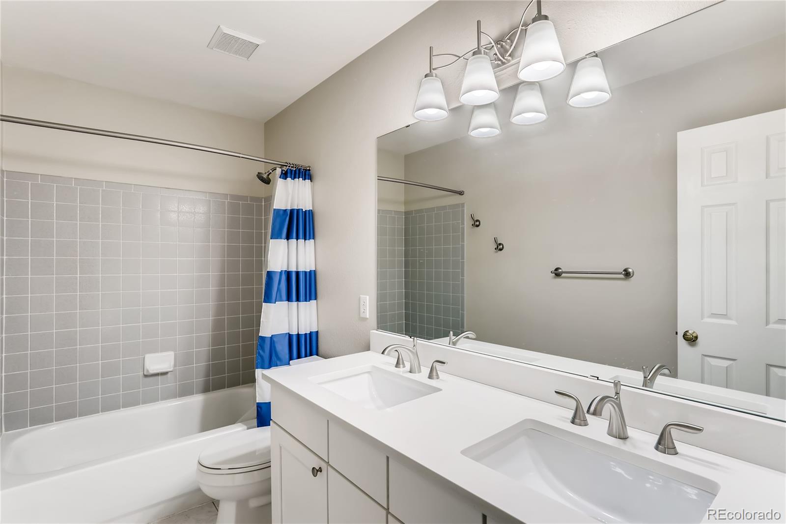 2883 East Ravenhill Circle Highlands Ranch, CO 80126 - Photo 16 of 25 a bathroom with a sink a toilet and shower