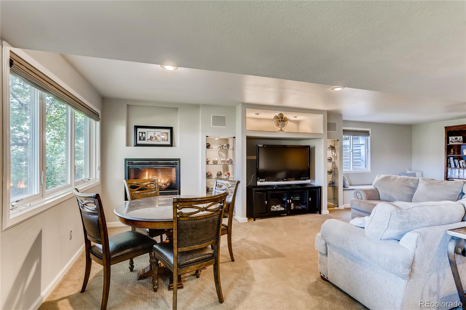 2883 East Ravenhill Circle Highlands Ranch, CO 80126 - Photo 17 of 25 a living room with furniture a flat screen tv and a fireplace