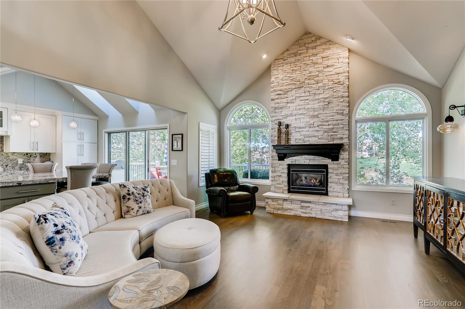 2883 East Ravenhill Circle Highlands Ranch, CO 80126 - Photo 3 of 25 a living room with furniture a large window and a fireplace