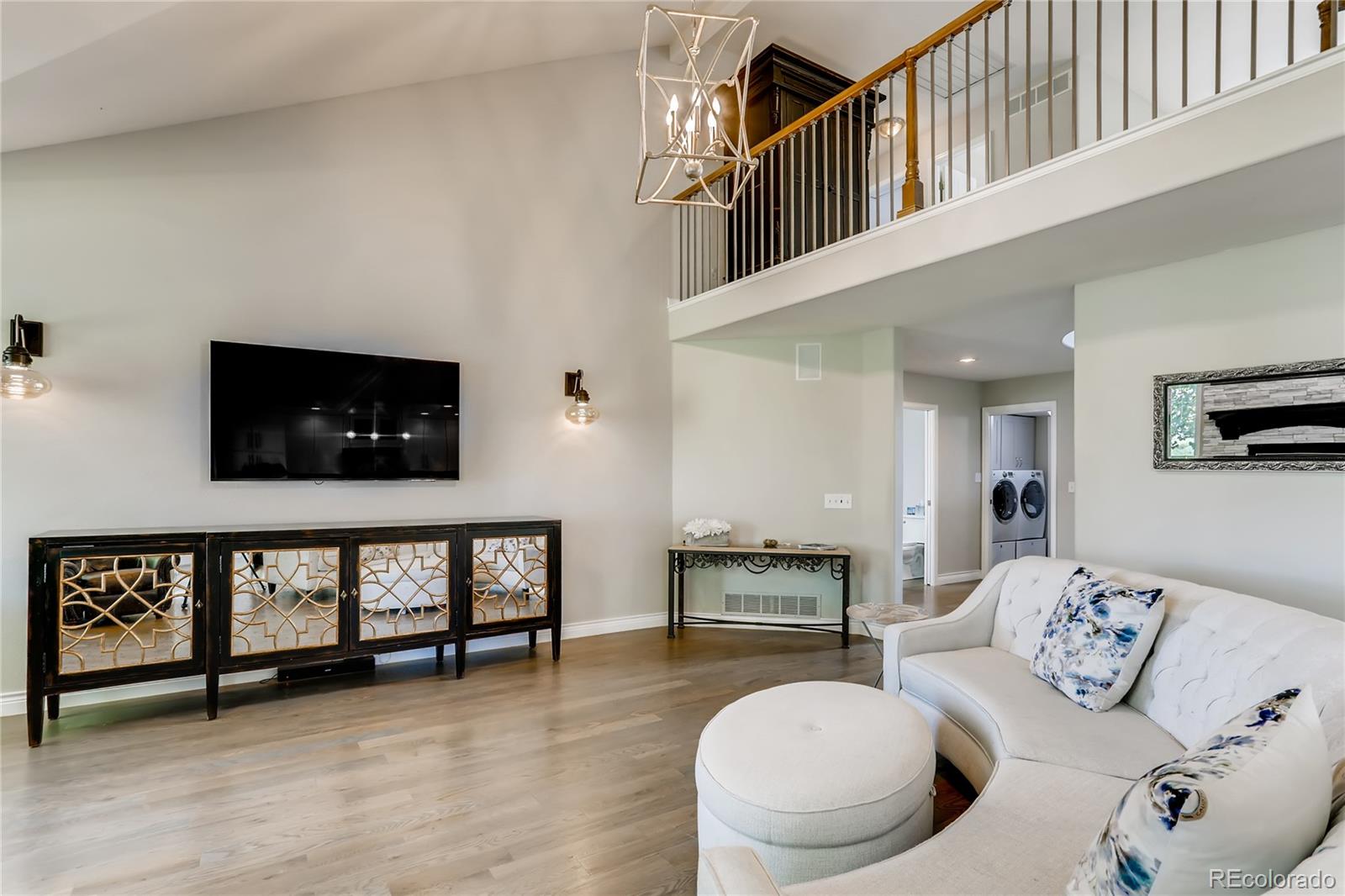 2883 East Ravenhill Circle Highlands Ranch, CO 80126 - Photo 5 of 25 a living room with furniture and a flat screen tv