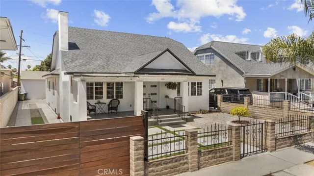 a view of a house with wooden fence