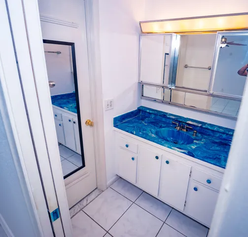 a bathroom with a sink a mirror and a vanity