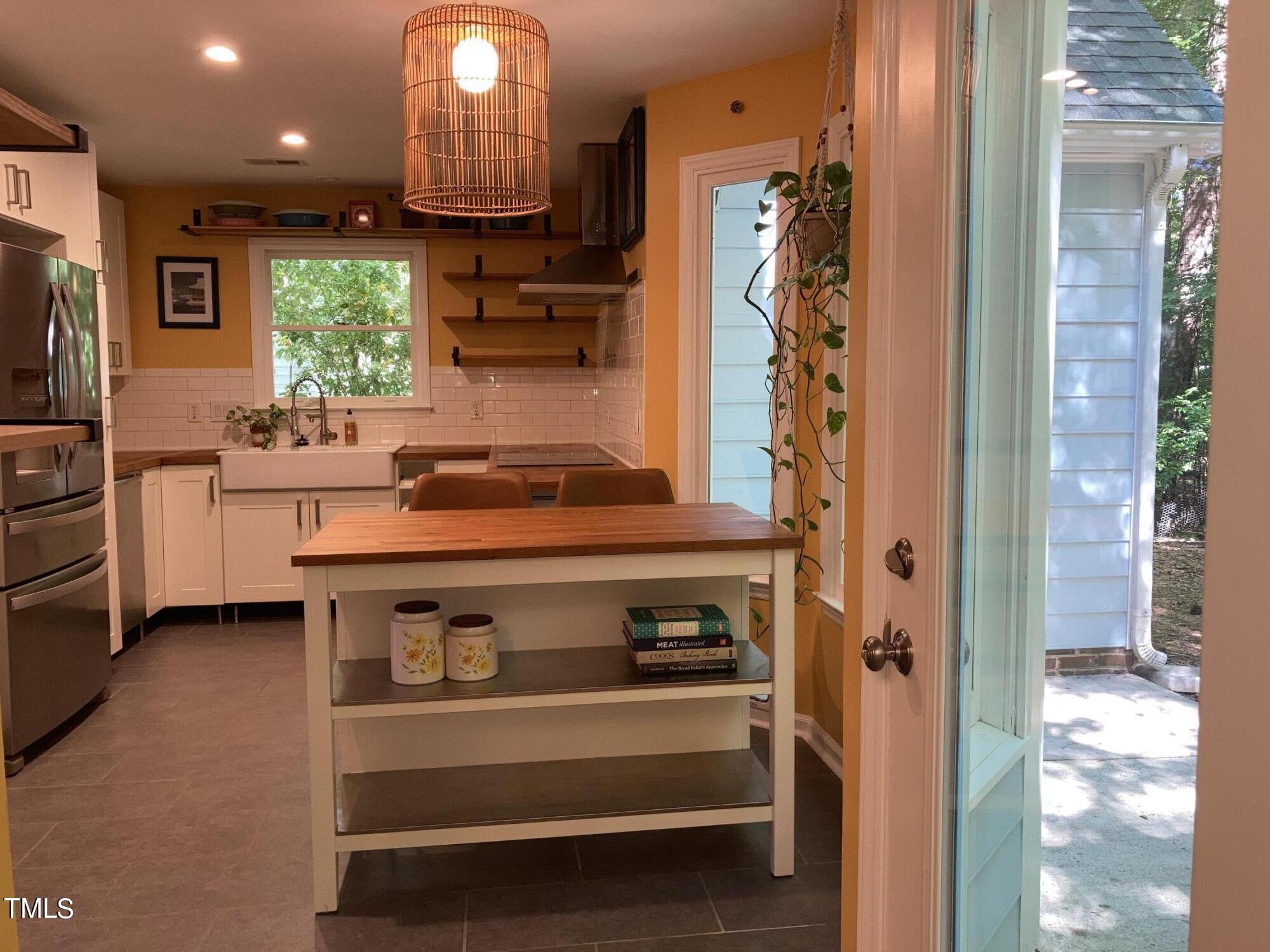 5315 Reams Run Road Durham, NC 27713 - Photo 10 of 49 a kitchen with stainless steel appliances granite countertop a stove and a sink