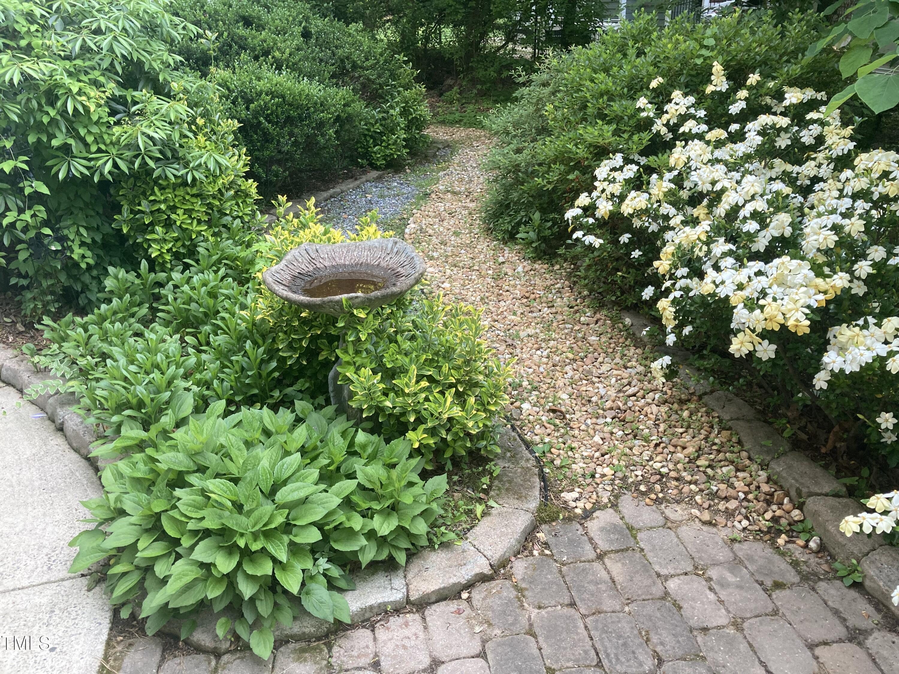 5315 Reams Run Road Durham, NC 27713 - Photo 41 of 49 a view of a garden with plants and a bench