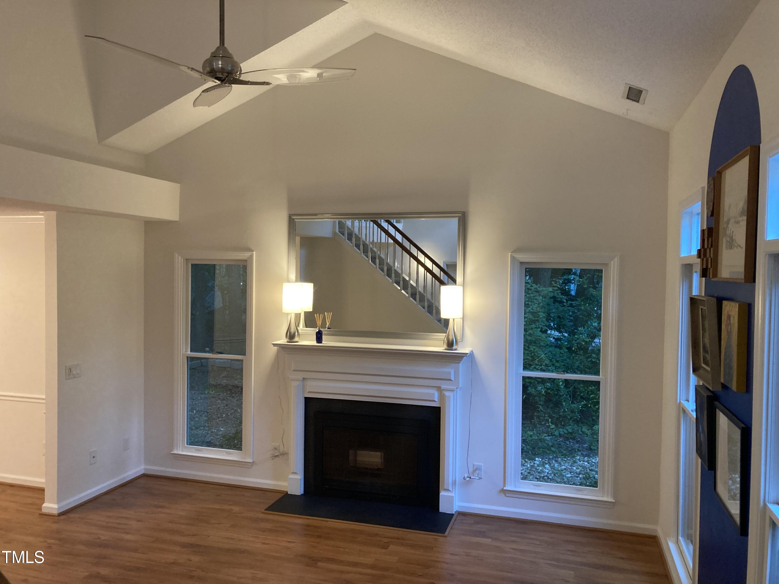 5315 Reams Run Road Durham, NC 27713 - Photo 5 of 49 an empty room with fireplace wooden floor and fan