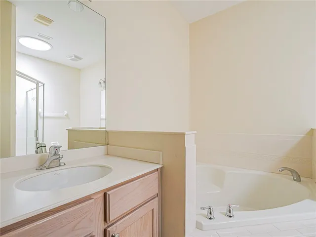 a bathroom with a granite countertop sink a toilet and a mirror