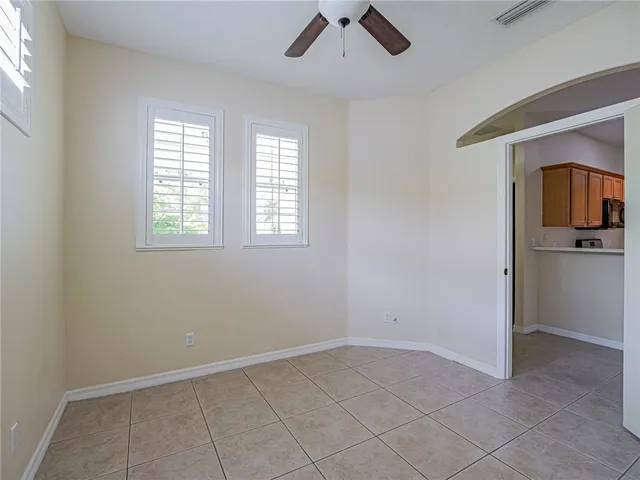a view of an empty room with closet and a window