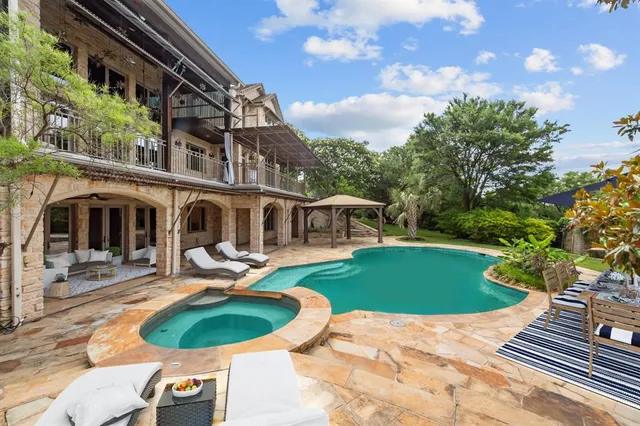 an aerial view of a house with a yard and large trees