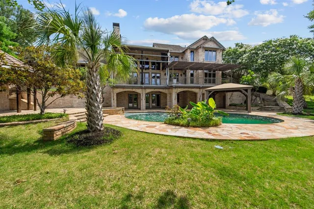 a bathroom with a granite countertop sink toilet a mirror a bathtub and shower