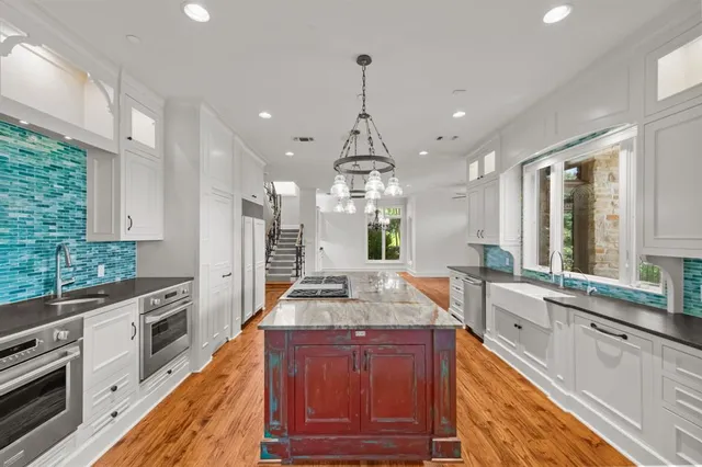 en empty room with windows and chandelier