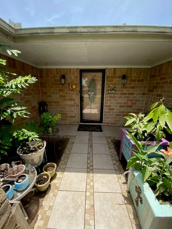 a view of a entryway with flower pots