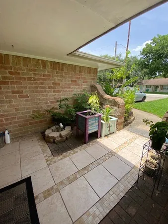 a terrace with outdoor seating and trees