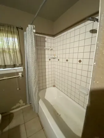 a bathroom with a bathtub and shower