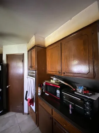 a kitchen with stainless steel appliances granite countertop a refrigerator and a stove