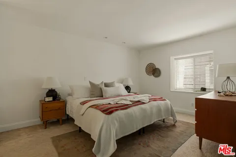 a bedroom with a bed and window