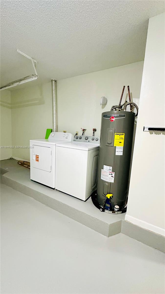 528 Southwest 166th Terrace Weston, FL 33326 - Photo 13 of 14 a utility room with dryer and washer