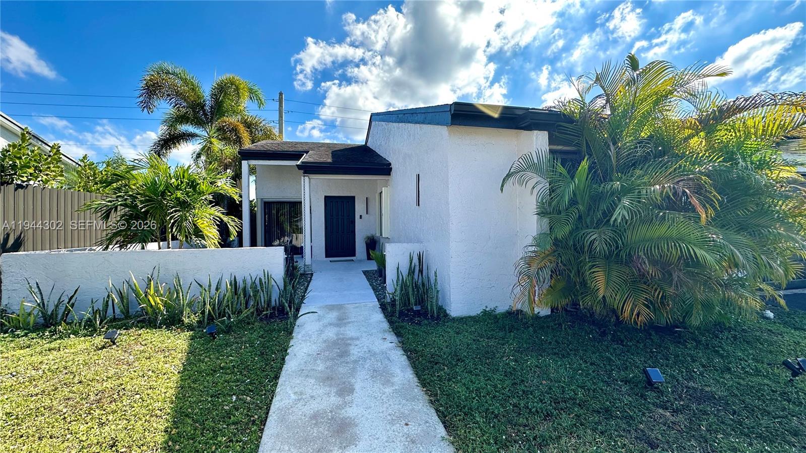 528 Southwest 166th Terrace Weston, FL 33326 - Photo 2 of 14 a front view of a house with a garden