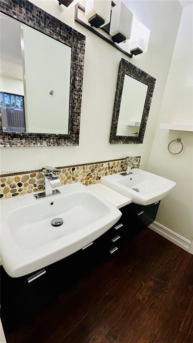 528 Southwest 166th Terrace Weston, FL 33326 - Photo 7 of 14 a bathroom with a sink and a mirror