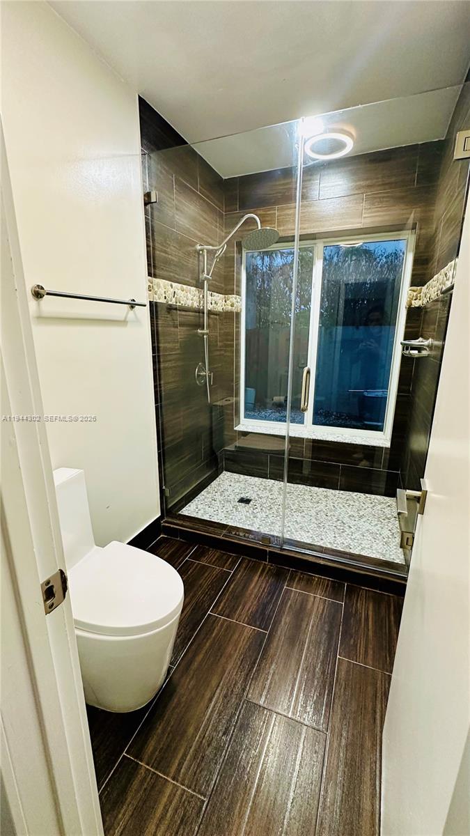 528 Southwest 166th Terrace Weston, FL 33326 - Photo 8 of 14 a bathroom with a granite countertop sink toilet and shower