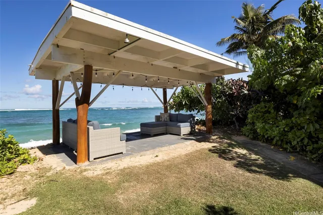 a view of a patio with a table and chairs under an umbrella