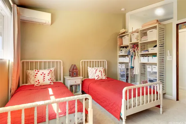 a bedroom with two beds and white walls