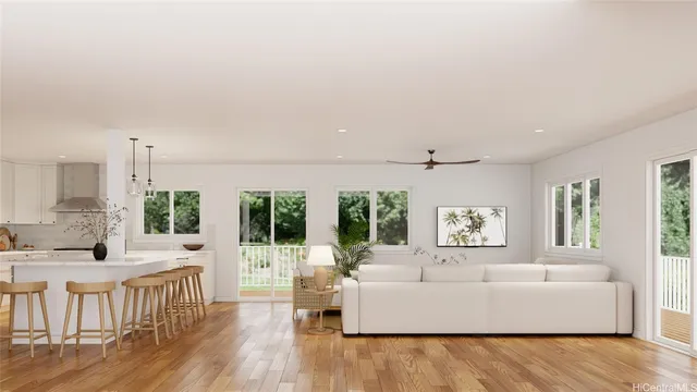 a living room with furniture wooden floor and a large window
