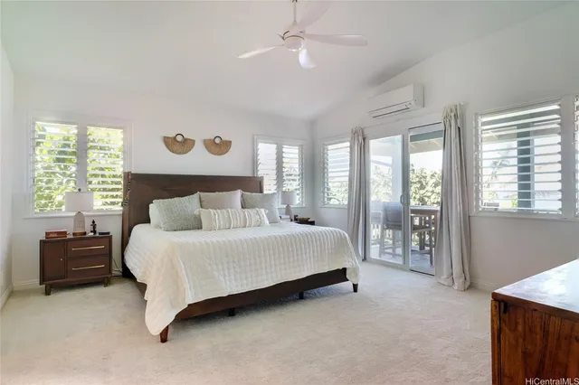 a spacious bedroom with a bed and a large window