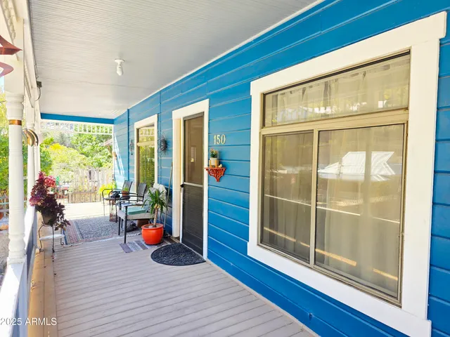 a wooden bench sitting in front of a building