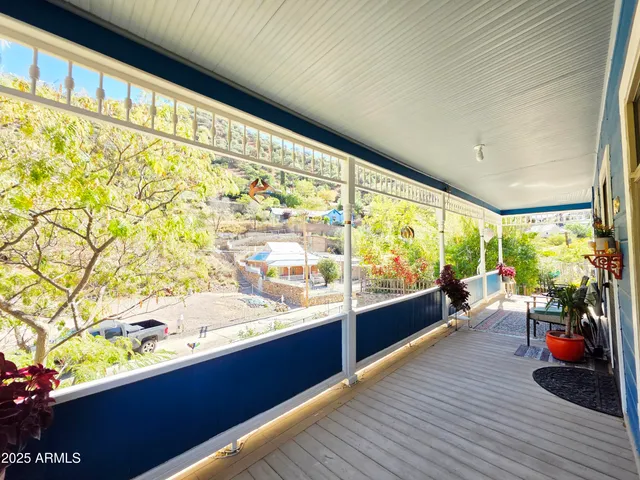 a view of a patio with a table and chairs and potted plants