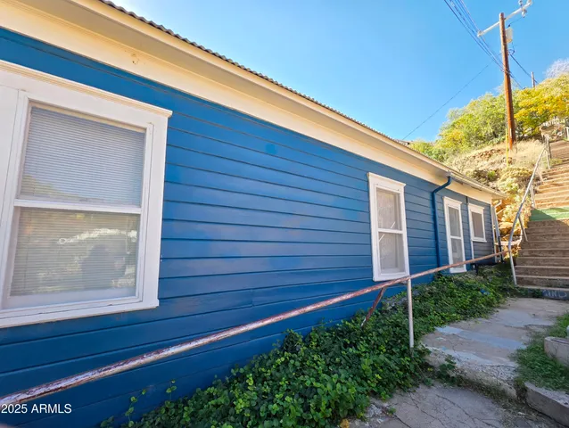 a living room with furniture flat screen tv and a large window