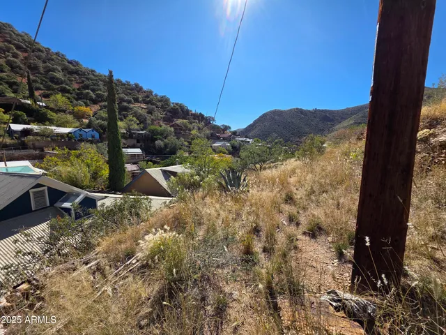 a living room with furniture floor to ceiling window and a flat screen tv