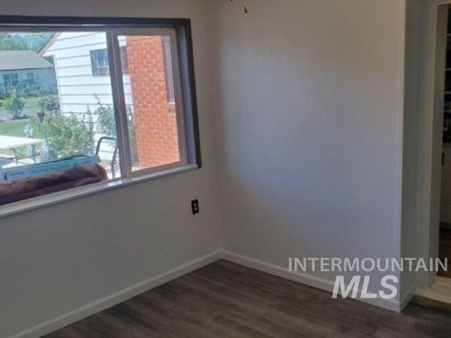 817 Union Avenue Filer, ID 83328 - Photo 19 of 37 Empty room featuring baseboards and dark wood finished floors