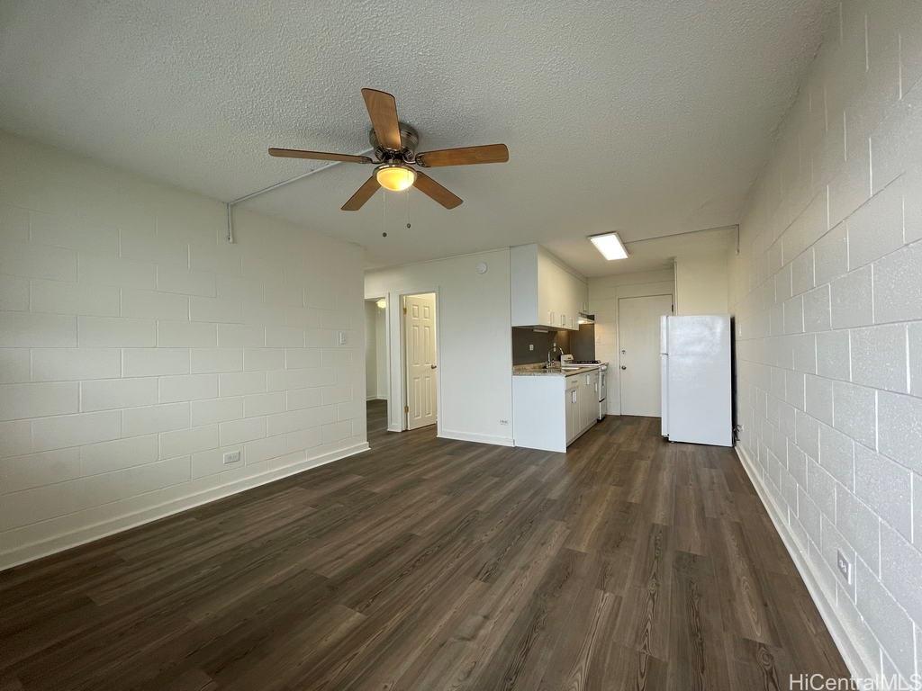 828 Puuhale Road, Unit 308 Honolulu, HI 96819 - Photo 1 of 1 a view of a kitchen with wooden floor and a ceiling fan