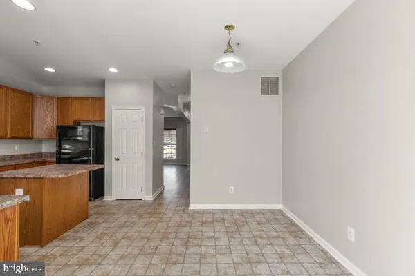 a view of a kitchen with stainless steel appliances a refrigerator and a sink