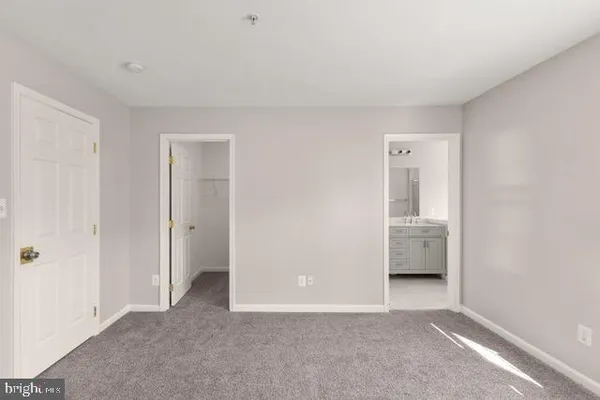 a view of room with sink and cabinet
