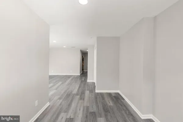 a view of a room with wooden floor and white walls