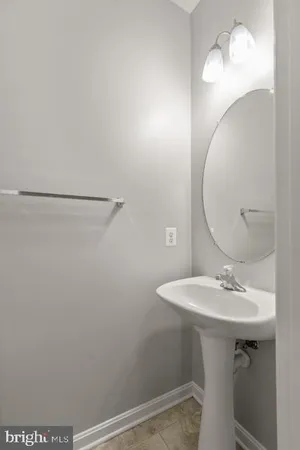 a bathroom with a sink a mirror and vanity