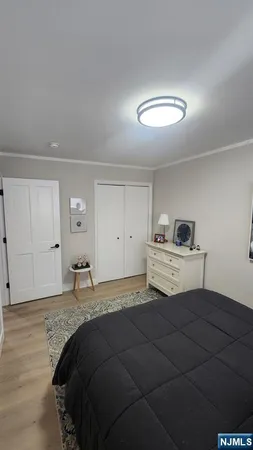 a bedroom with a bed and a lamp